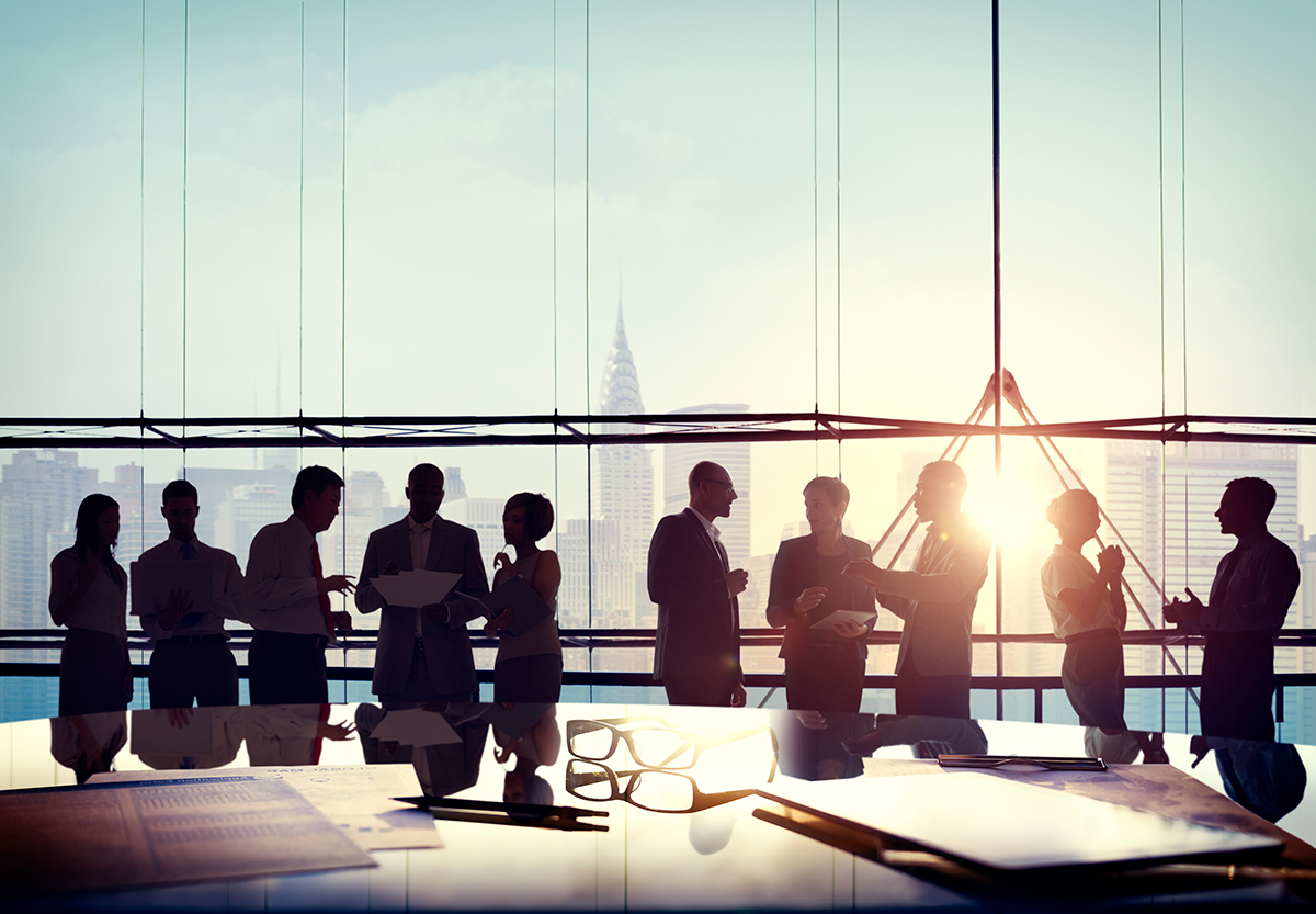 executive team discussing leadership restructuring in a boardroom