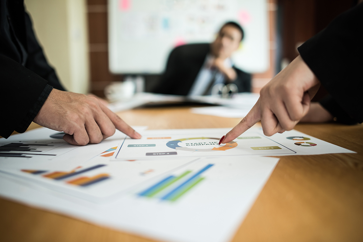 fiduciary reviewing financial data with stakeholders during Chapter 11 bankruptcy