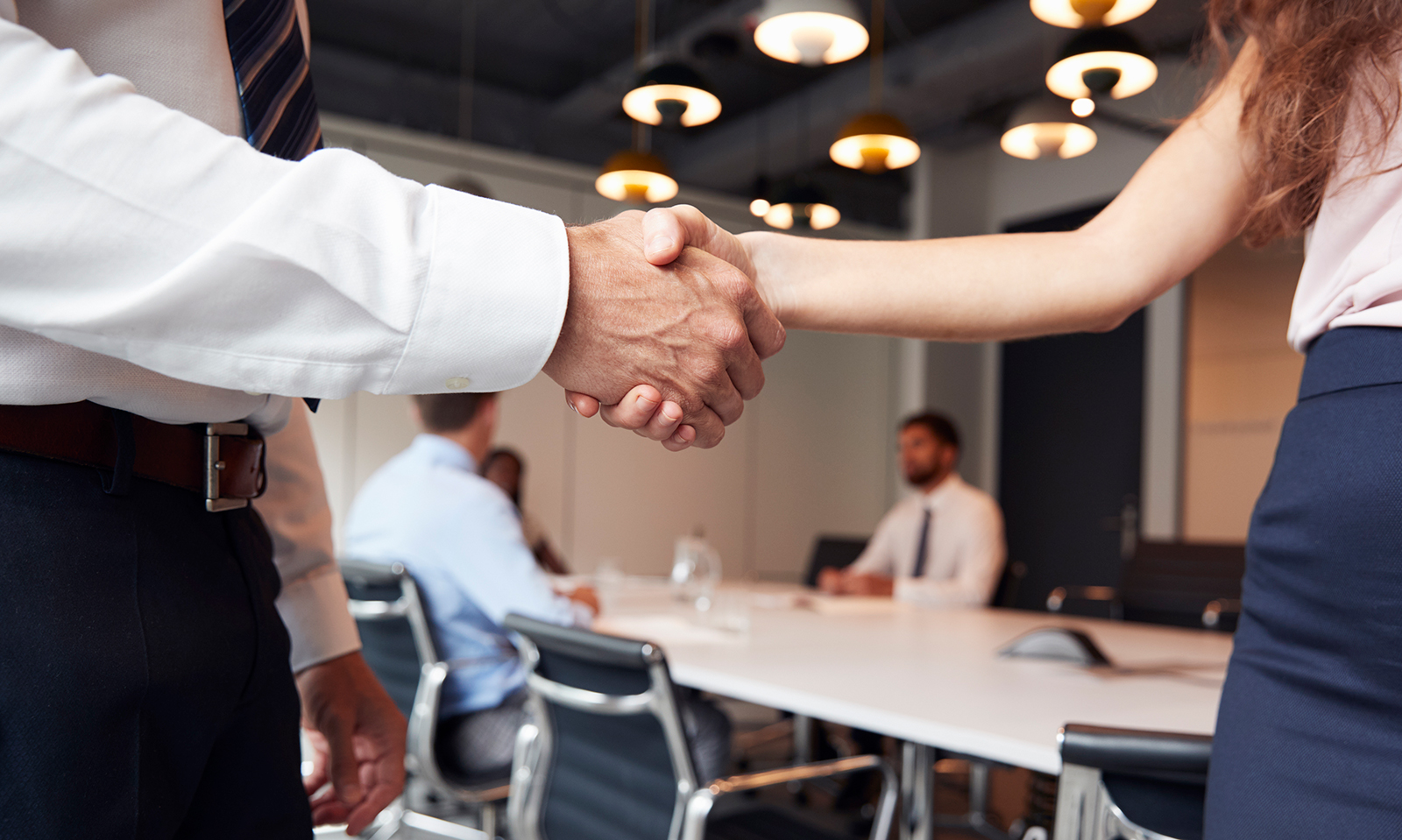 Business professionals reaching agreement through mediation in bankruptcy dispute resolution
