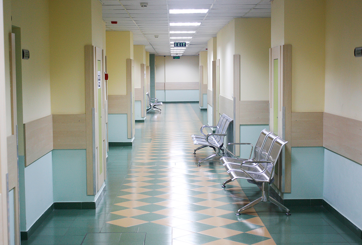 Empty corridor with waiting chairs inside a hospital